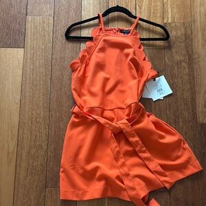 Victoria Beckham for Target.  Orange Halter romper with Scalloped Edges